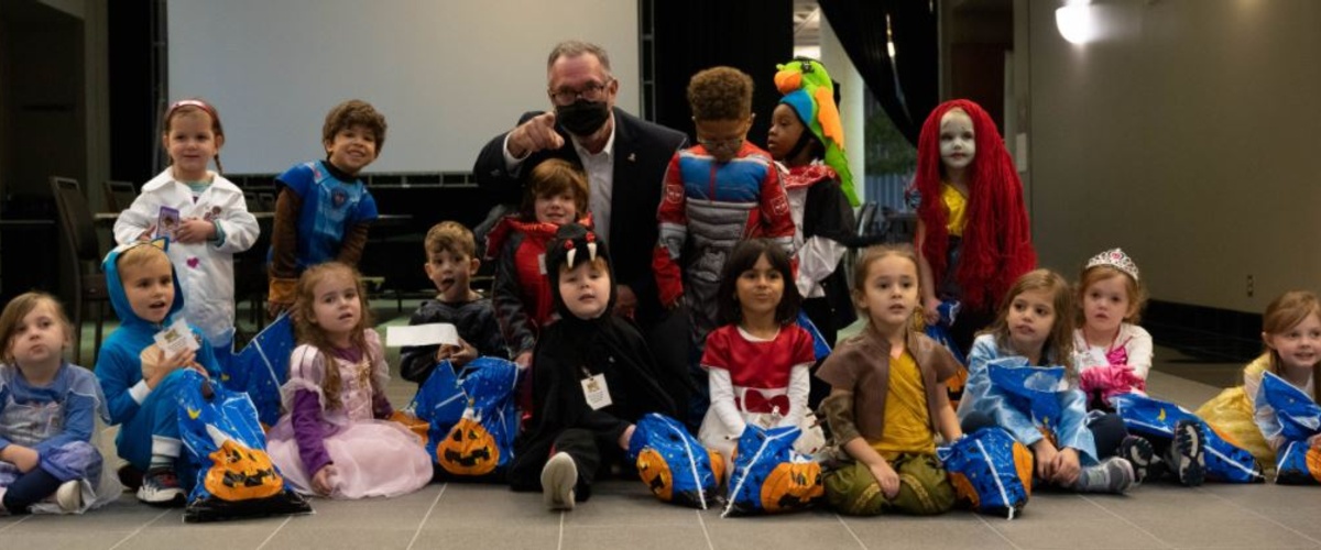 Children from Mini-University visit with President Johnson October 29 during their annual Halloween costume parade around campus.